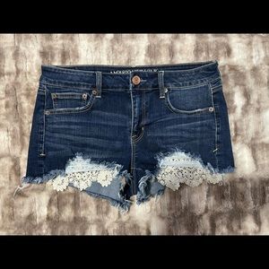 American eagle distressed shorts; lace accents; size 10